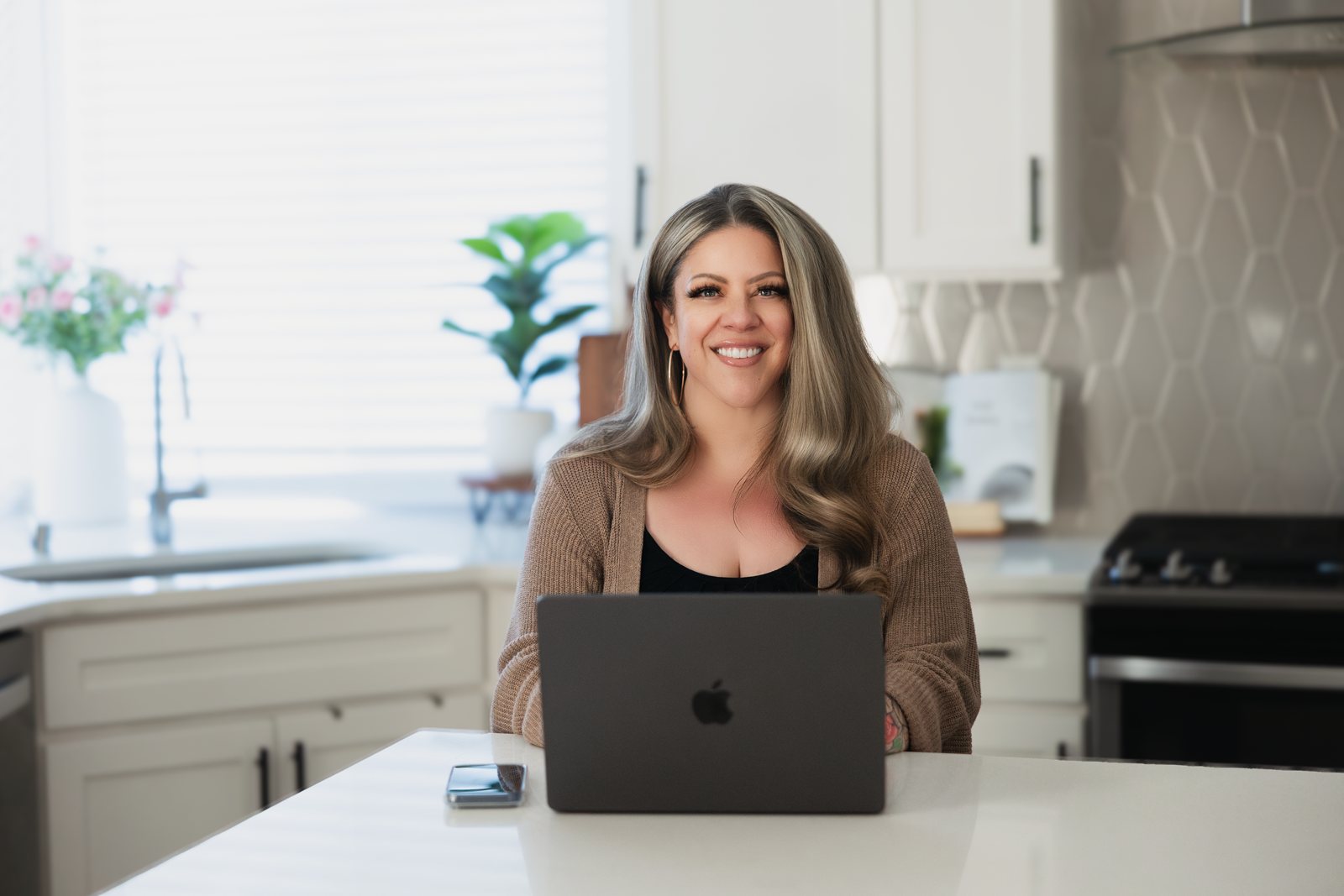 Julie Wagner, founder of Leadership Clearly, working at her laptop